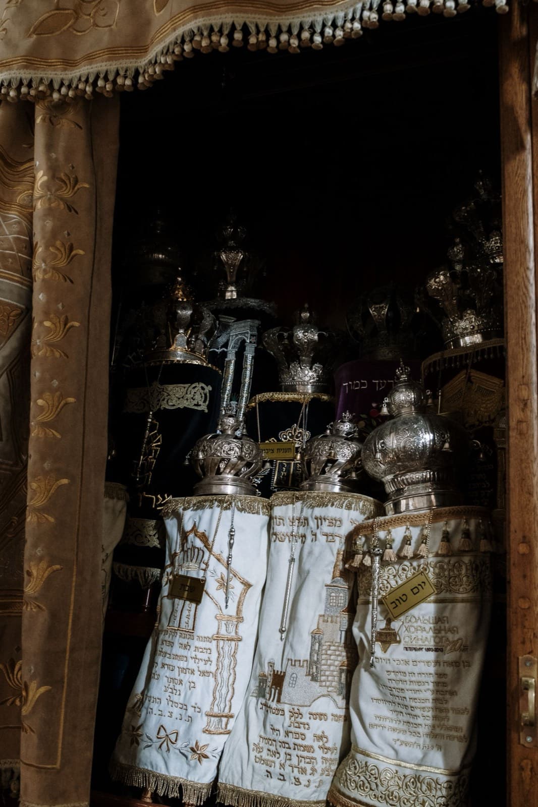Torah scrolls in embroidered covers inside an open ark